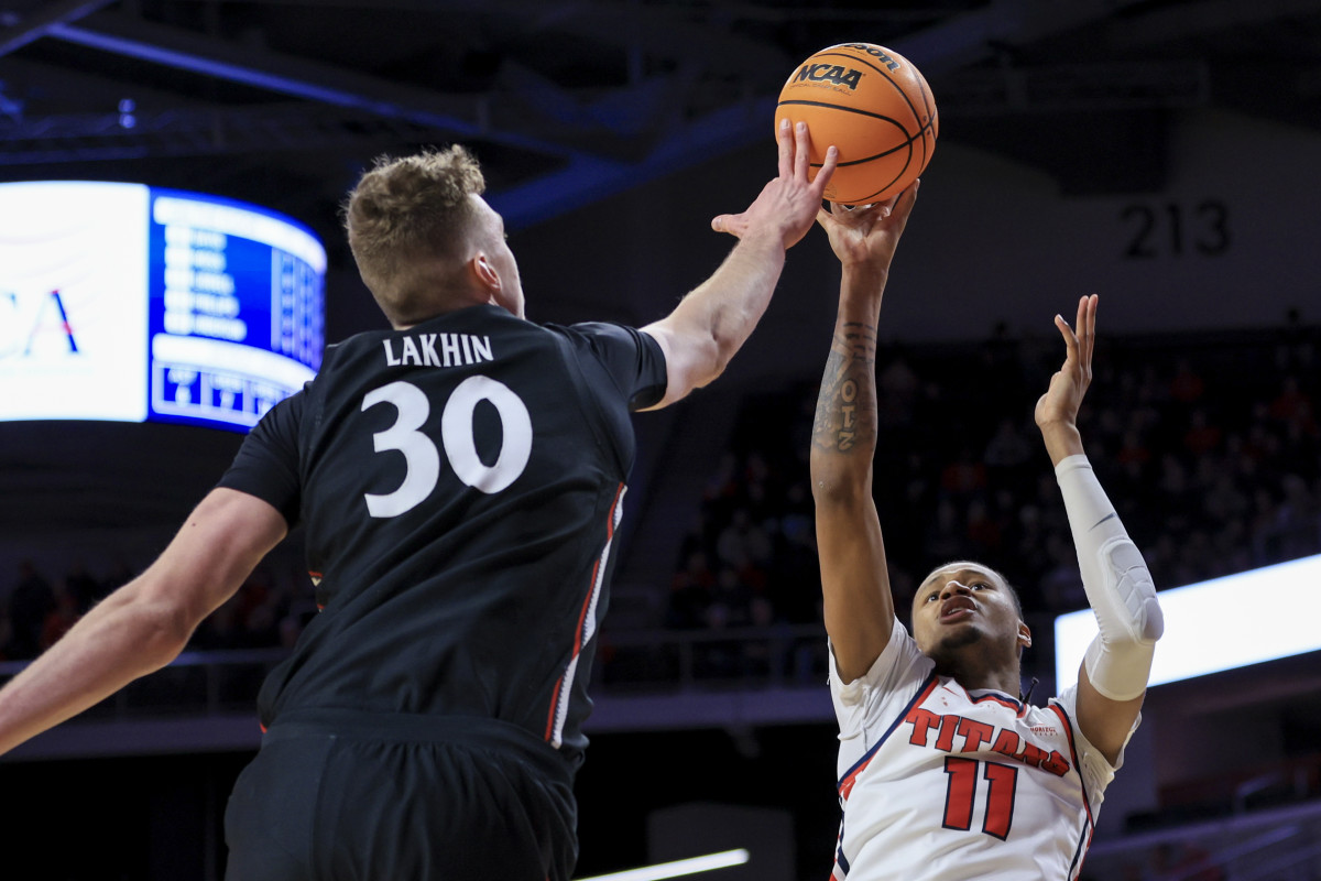 Dec 21, 2022; Cincinnati, Ohio, USA; Cincinnati Bearcats forward Viktor Lakhin (30) blocks the shot by Detroit Mercy Titans forward Gerald Liddell (11) in the second half at Fifth Third Arena. Mandatory Credit: Aaron Doster-USA TODAY Sports